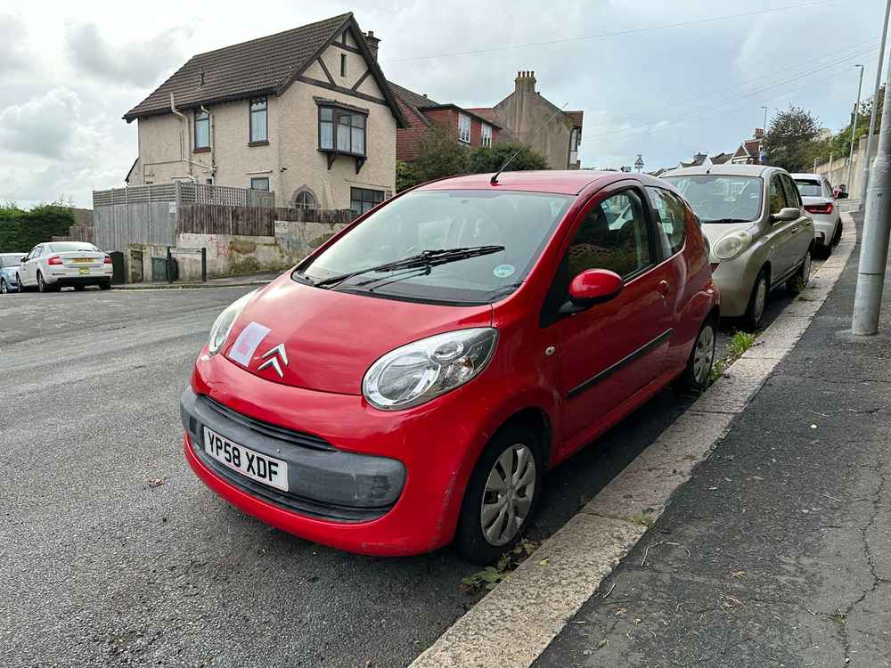 Photograph of YP58 XDF - a Red Citroen C1 parked in Hollingdean by a non-resident, and potentially abandoned. The first of twenty photographs supplied by the residents of Hollingdean.