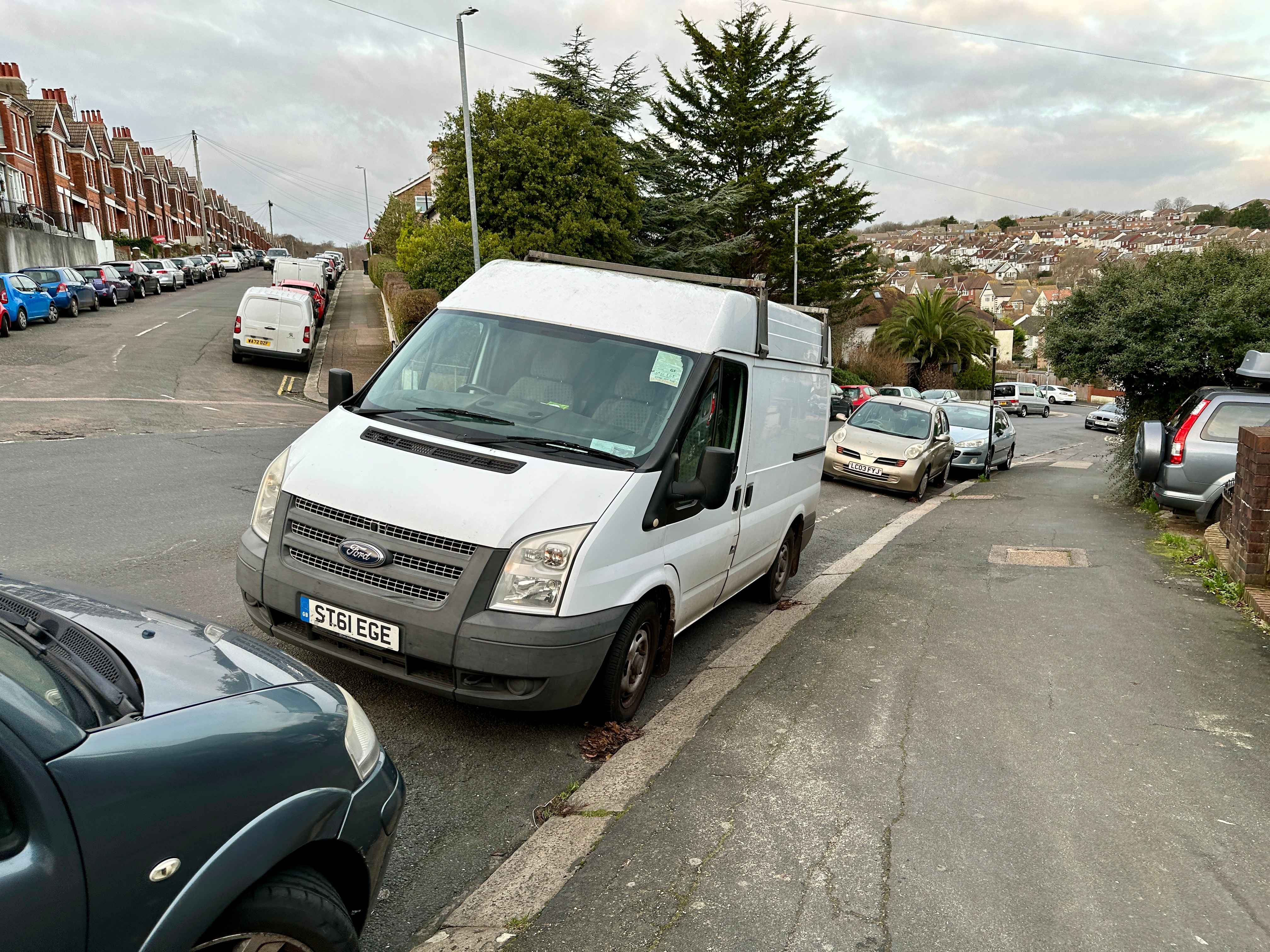 Photograph of ST61 EGE - a White Ford Transit parked in Hollingdean by a non-resident. The sixth of six photographs supplied by the residents of Hollingdean.