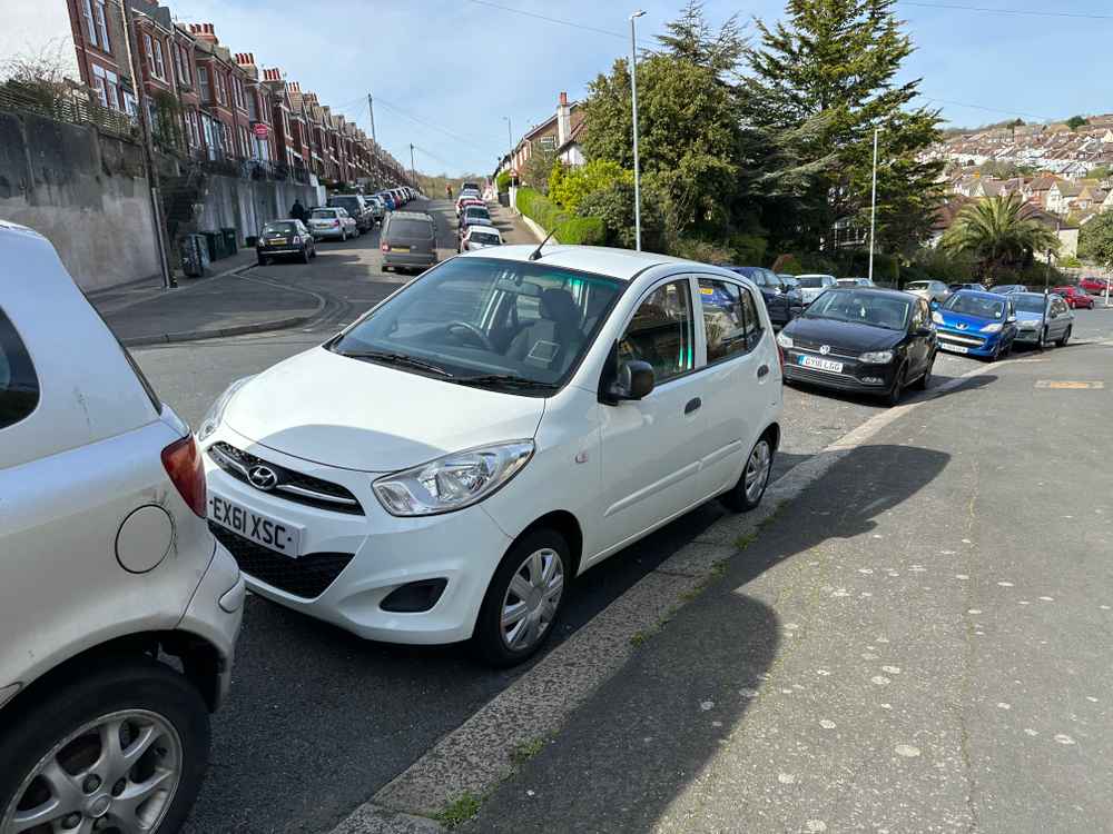 Photograph of EX61 XSC - a White Hyundai i10 parked in Hollingdean by a non-resident who uses the local area as part of their Brighton commute. The third of three photographs supplied by the residents of Hollingdean.