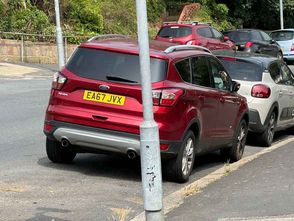 Photograph of EA67 JVX - a Red Ford Kuga parked in Hollingdean by a non-resident. The second of three photographs supplied by the residents of Hollingdean.