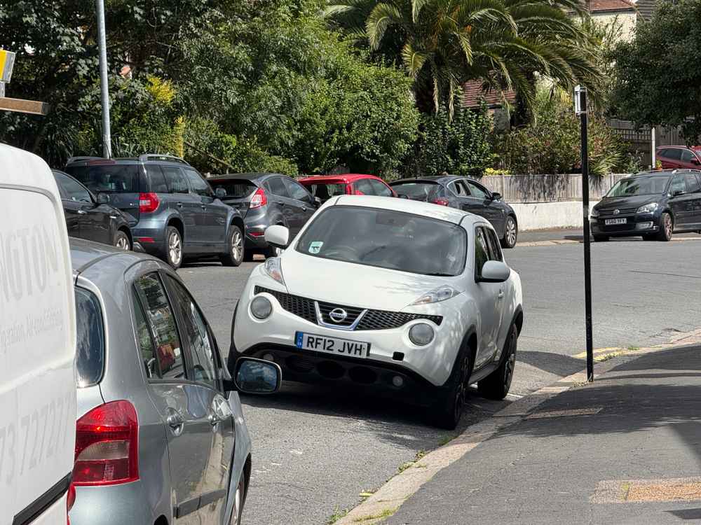 Photograph of RF12 JVH - a White Nissan Juke parked in Hollingdean by a non-resident who uses the local area as part of their Brighton commute. The twentieth of twenty photographs supplied by the residents of Hollingdean.