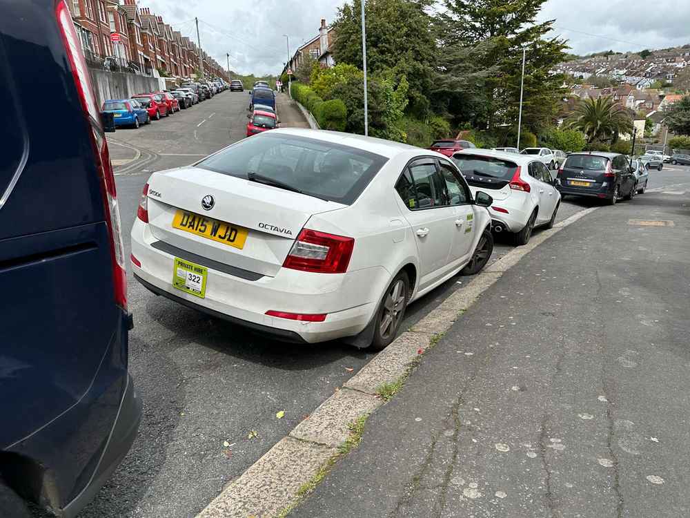 Photograph of DA15 WJD - a White Skoda Octavia taxi parked in Hollingdean by a non-resident. The eighth of nineteen photographs supplied by the residents of Hollingdean.