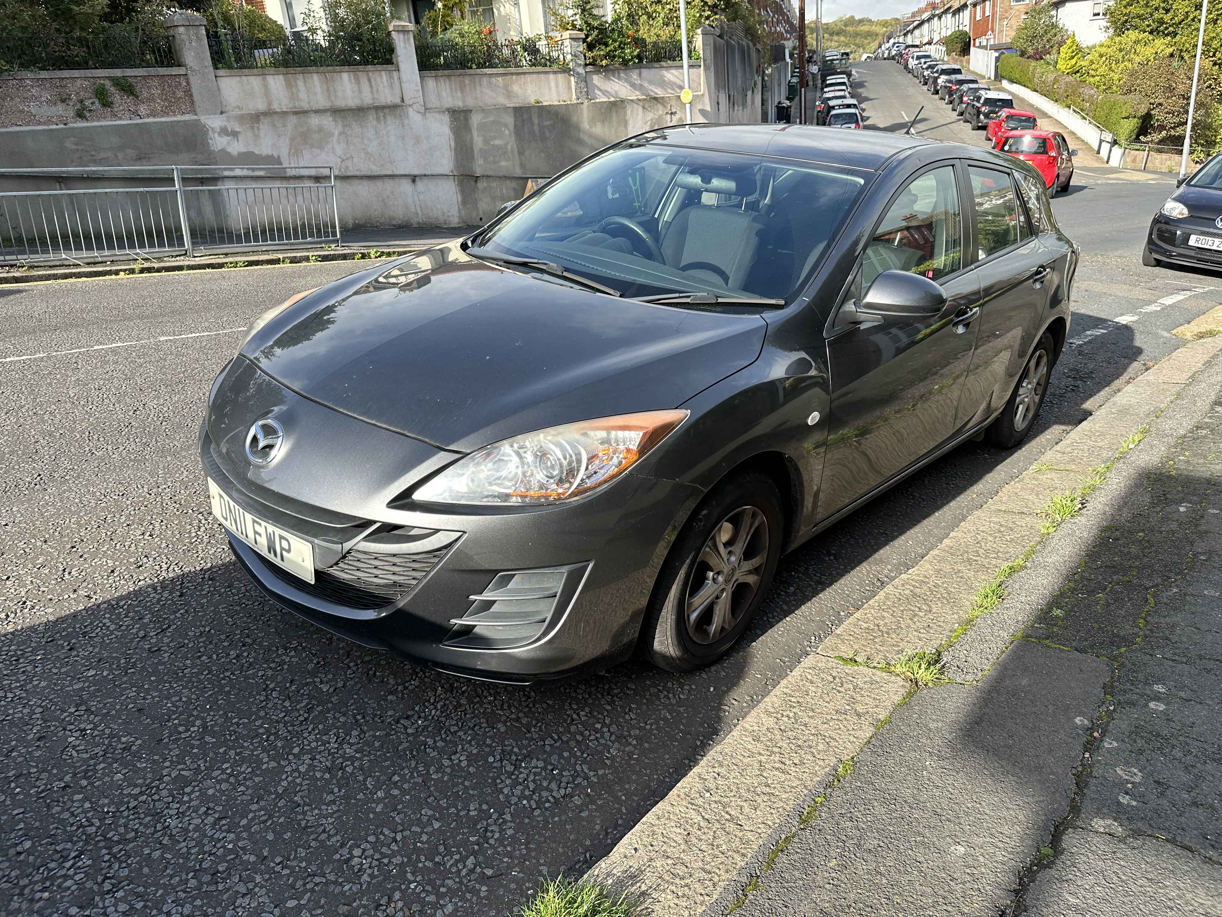 Photograph of DN11 FWP - a Grey Mazda 3 parked in Hollingdean by a non-resident who uses the local area as part of their Brighton commute. 