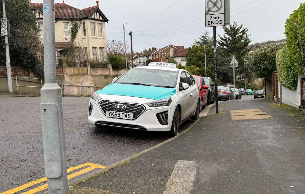 Photograph of YK69 TAS - a White Hyundai Ioniq taxi parked in Hollingdean by a non-resident. The fifth of fifteen photographs supplied by the residents of Hollingdean.