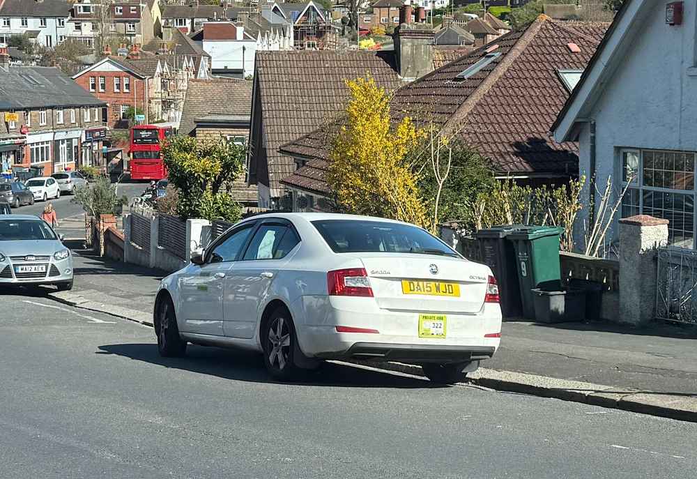 Photograph of DA15 WJD - a White Skoda Octavia taxi parked in Hollingdean by a non-resident. The seventeenth of nineteen photographs supplied by the residents of Hollingdean.