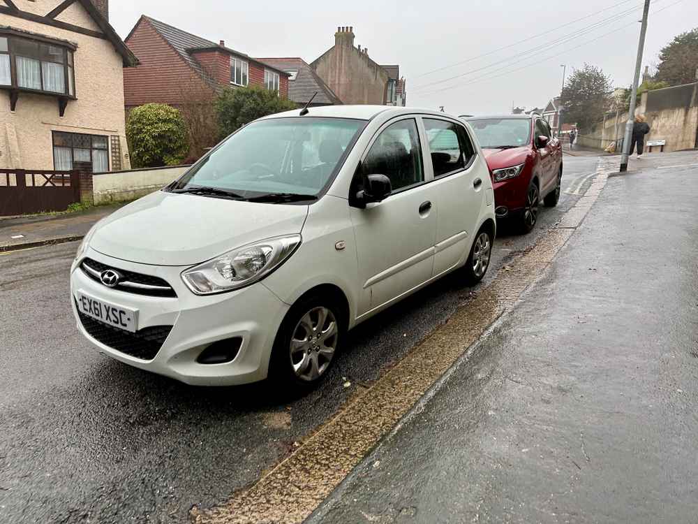 Photograph of EX61 XSC - a White Hyundai i10 parked in Hollingdean by a non-resident who uses the local area as part of their Brighton commute. The second of three photographs supplied by the residents of Hollingdean.