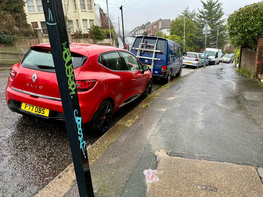 Photograph of P77 OBS - a Red Renault Clio parked in Hollingdean by a non-resident. The second of four photographs supplied by the residents of Hollingdean.