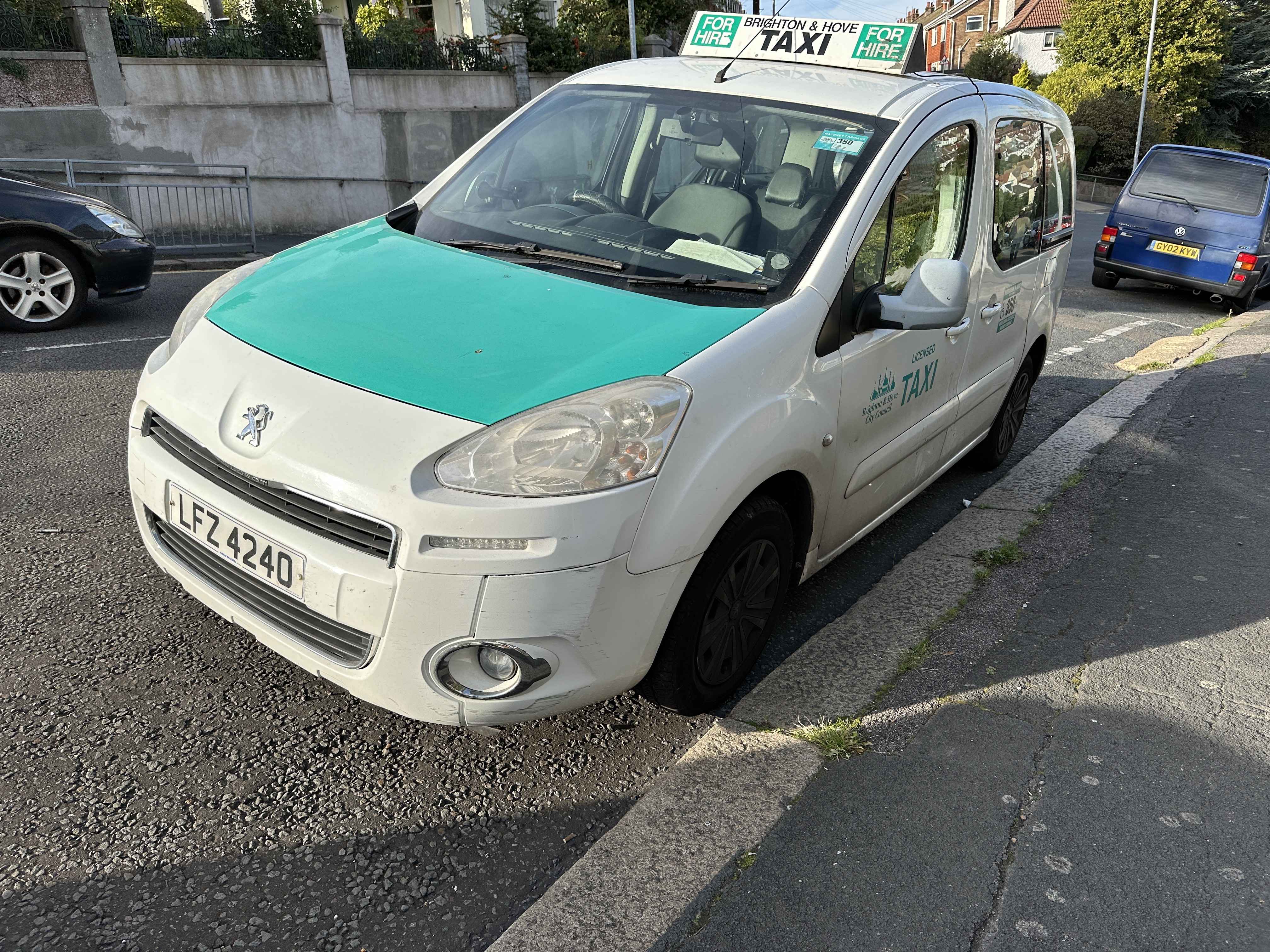 Photograph of LFZ 4240 - a White Peugeot Partner taxi parked in Hollingdean by a non-resident. The first of three photographs supplied by the residents of Hollingdean.