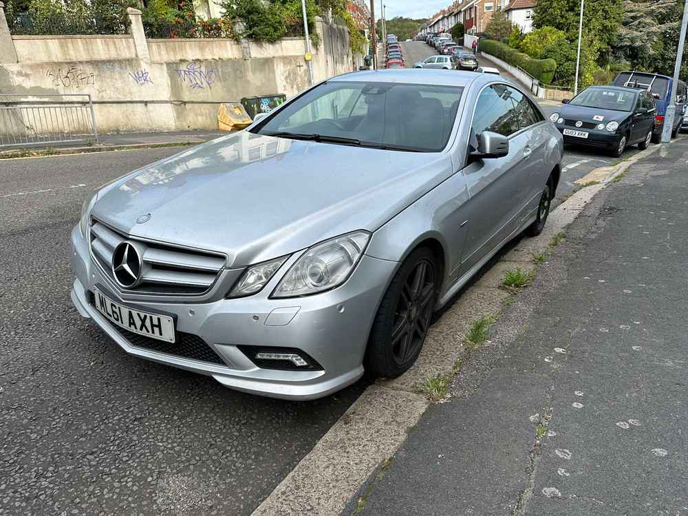 Photograph of ML61 AXH - a SIlver Mercedes E Class parked in Hollingdean by a non-resident, and potentially abandoned. The first of five photographs supplied by the residents of Hollingdean.