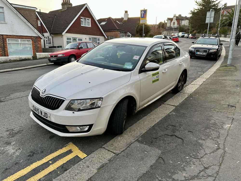 Photograph of DA15 WJD - a White Skoda Octavia taxi parked in Hollingdean by a non-resident. The fifth of nineteen photographs supplied by the residents of Hollingdean.