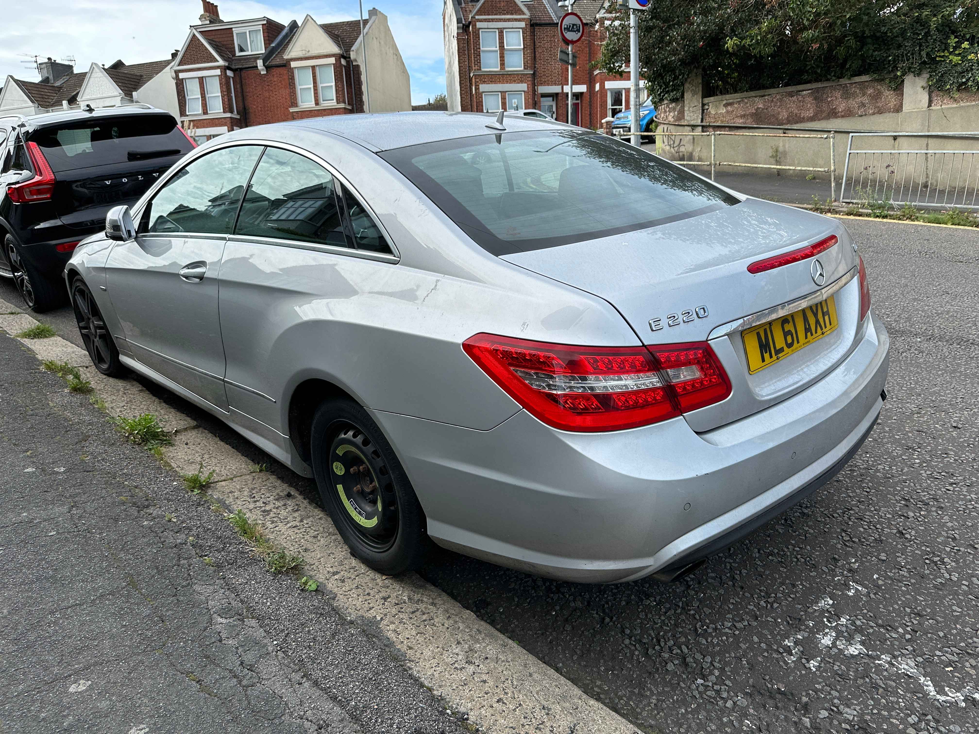 Photograph of ML61 AXH - a SIlver Mercedes E Class parked in Hollingdean by a non-resident, and potentially abandoned. The second of five photographs supplied by the residents of Hollingdean.