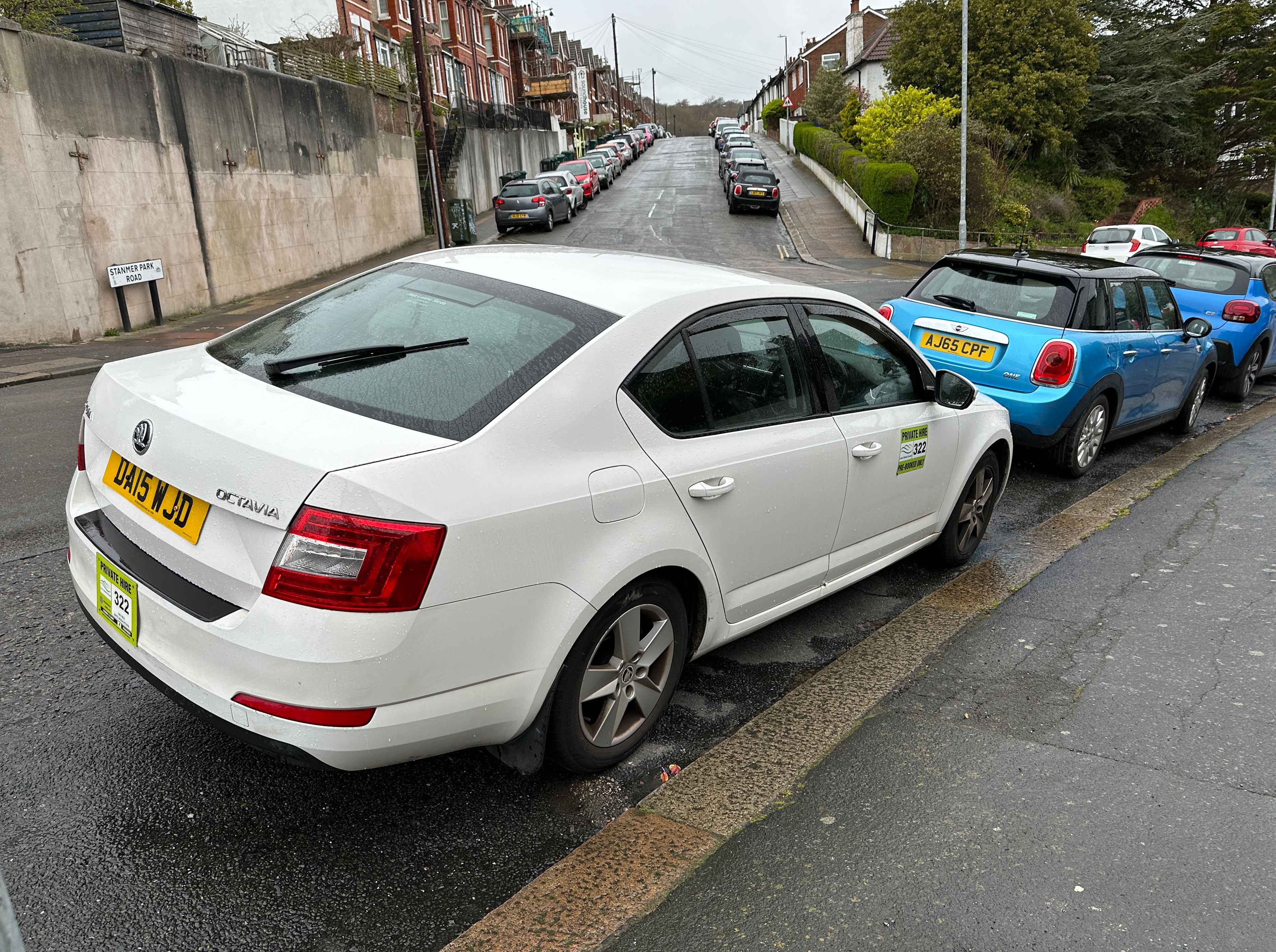 Photograph of DA15 WJD - a White Skoda Octavia taxi parked in Hollingdean by a non-resident. The second of five photographs supplied by the residents of Hollingdean.