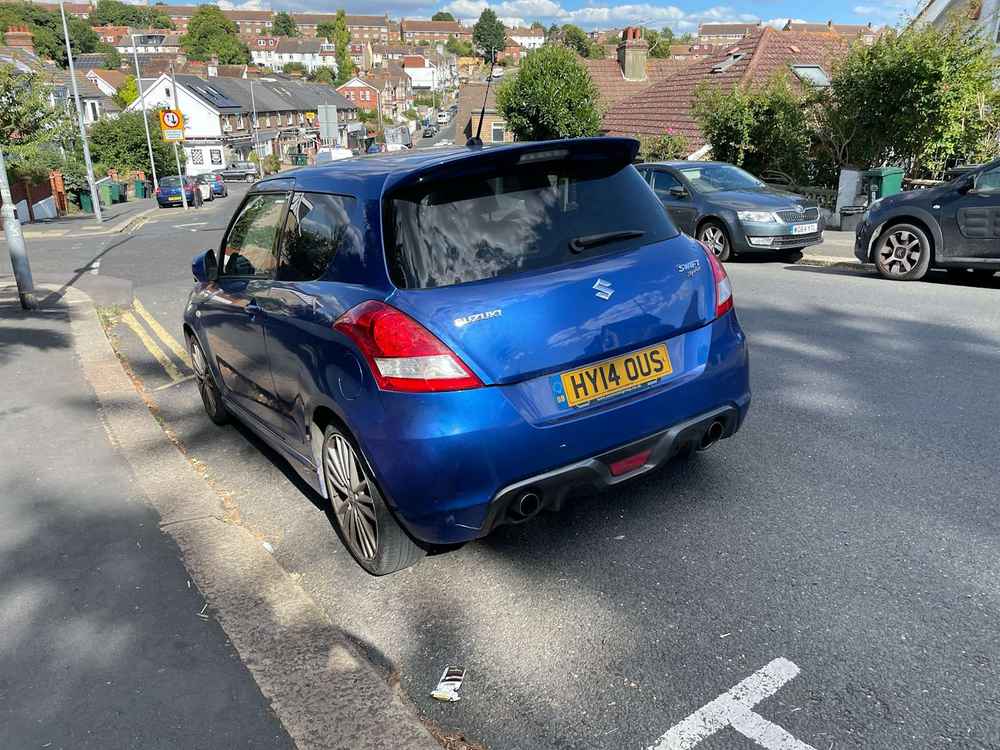 Photograph of HY14 OUS - a Blue Suzuki Swift parked in Hollingdean by a non-resident. The second of four photographs supplied by the residents of Hollingdean.
