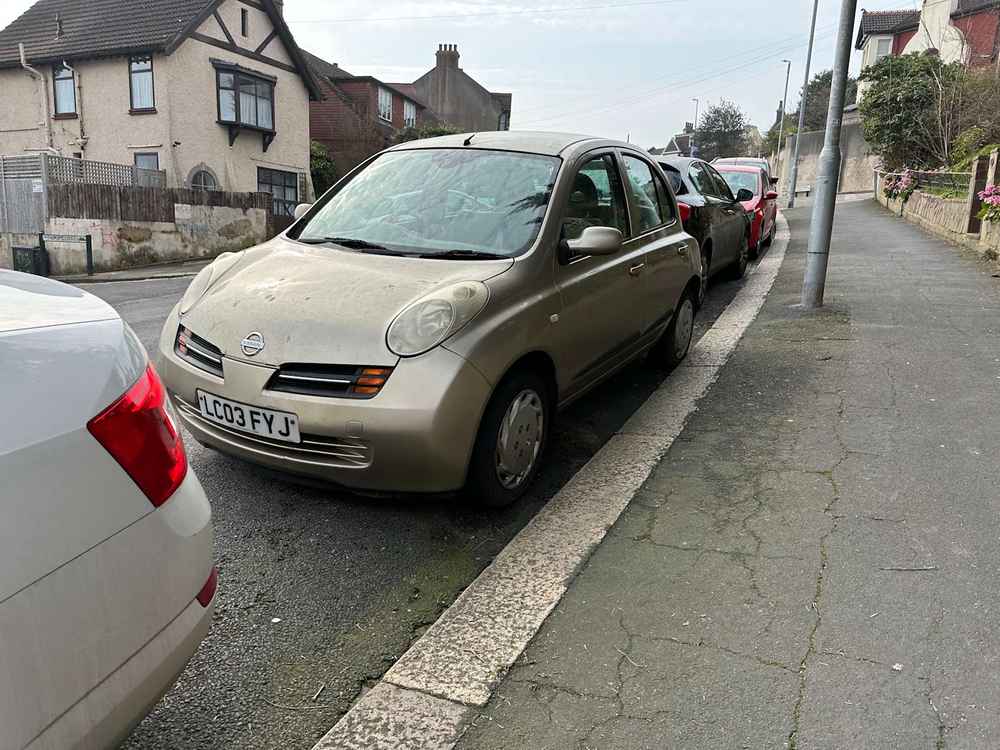Photograph of LC03 FYJ - a Gold Nissan Micra parked in Hollingdean by a non-resident, and potentially abandoned. The fourteenth of twenty-eight photographs supplied by the residents of Hollingdean.