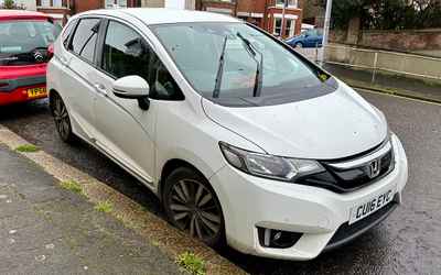 CU16 EYC, a White Honda Jazz parked in Hollingdean