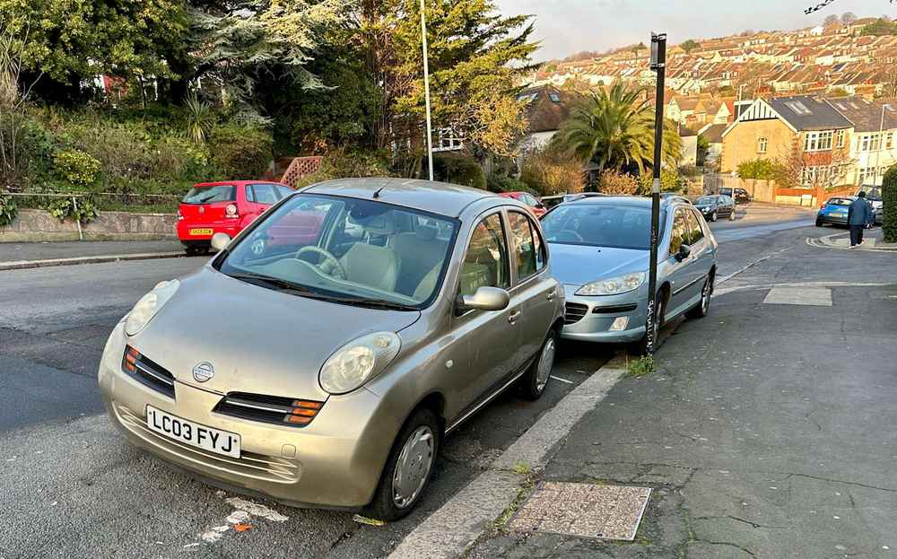 Photograph of LC03 FYJ - a Gold Nissan Micra parked in Hollingdean by a non-resident, and potentially abandoned. The tenth of twenty-eight photographs supplied by the residents of Hollingdean.