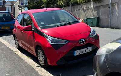 GU18 YEL, a Red Toyota Aygo parked in Hollingdean