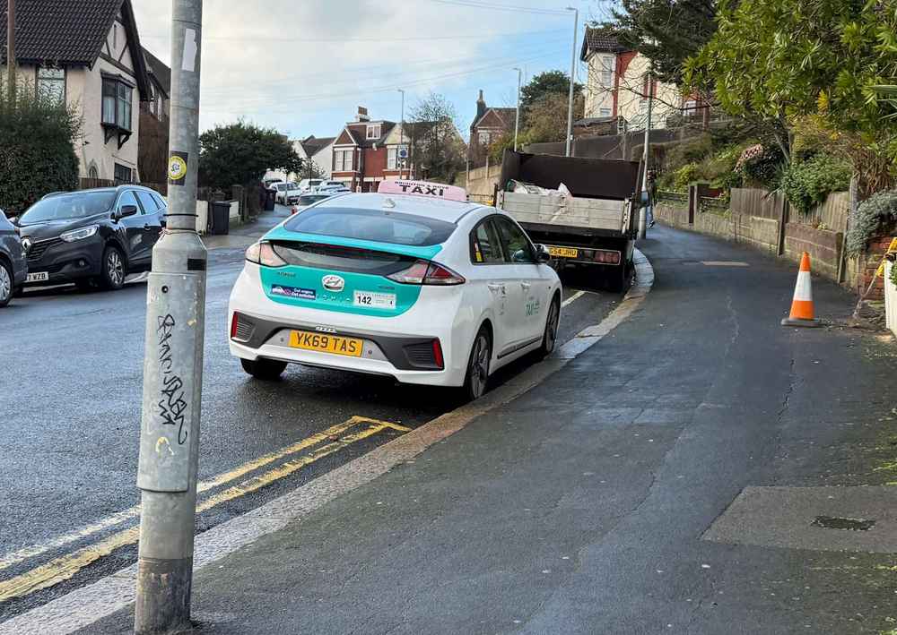 Photograph of YK69 TAS - a White Hyundai Ioniq taxi parked in Hollingdean by a non-resident. The fifteenth of fifteen photographs supplied by the residents of Hollingdean.