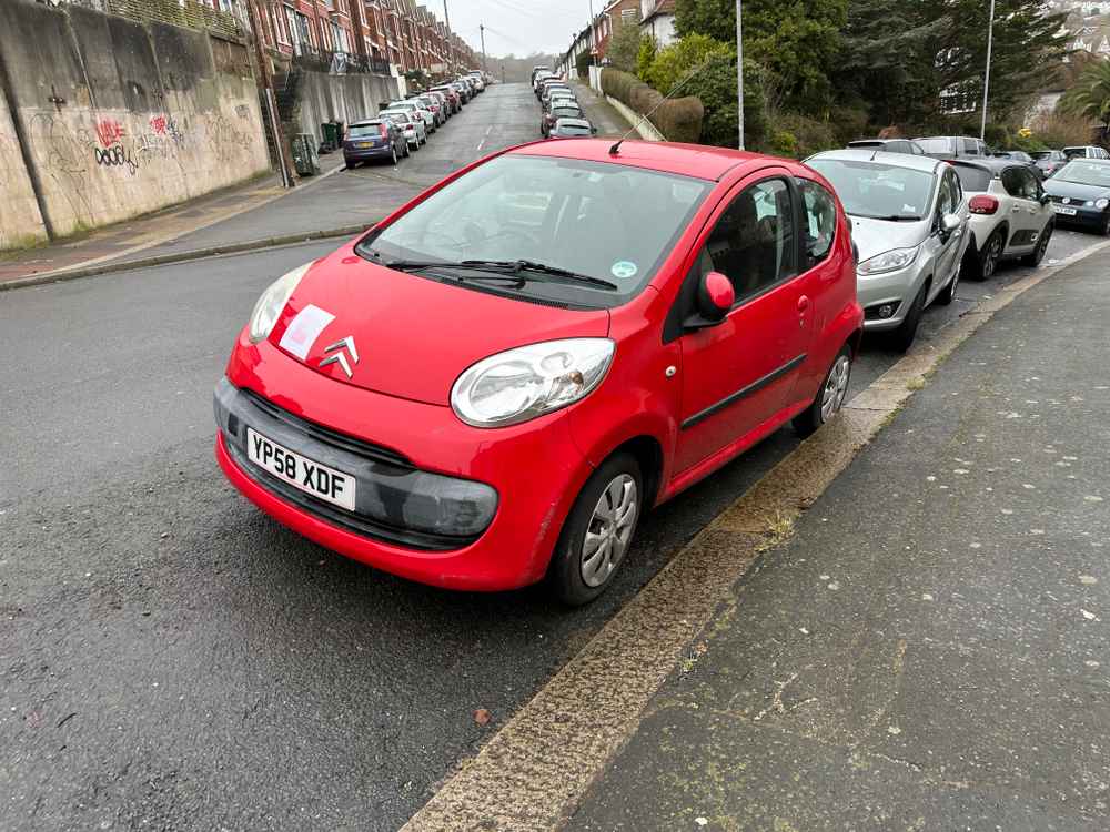 Photograph of YP58 XDF - a Red Citroen C1 parked in Hollingdean by a non-resident, and potentially abandoned. The fifth of seven photographs supplied by the residents of Hollingdean.