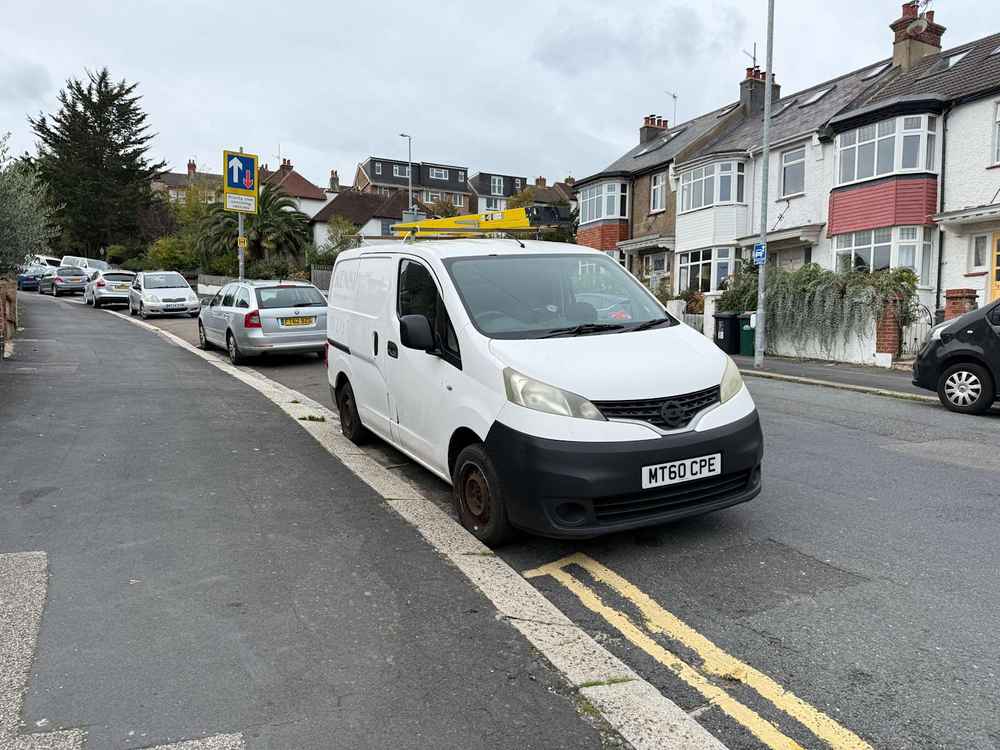 Photograph of MT60 CPE - a White Nissan NV200 parked in Hollingdean by a non-resident, and potentially abandoned. The sixteenth of sixteen photographs supplied by the residents of Hollingdean.