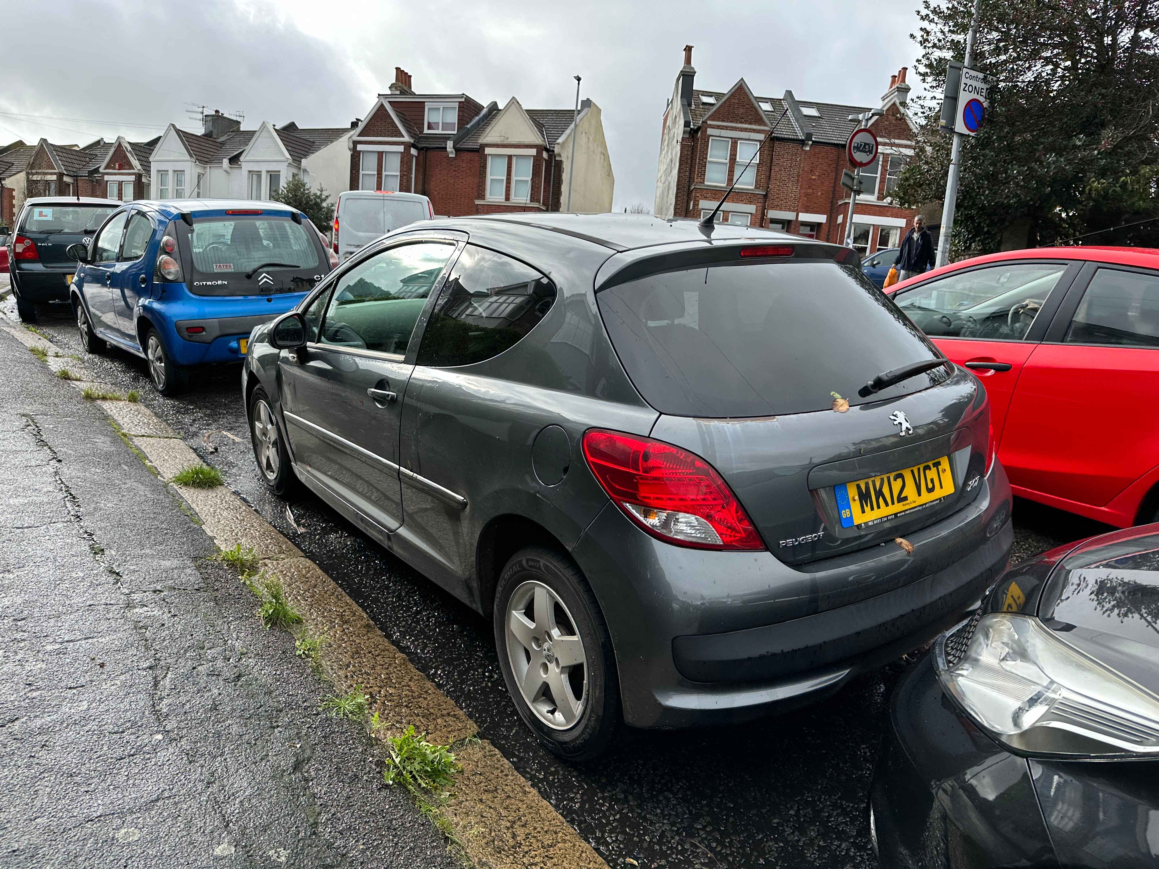 Photograph of MK12 VGT - a Grey Peugeot 207 parked in Hollingdean by a non-resident who uses the local area as part of their Brighton commute. The first of six photographs supplied by the residents of Hollingdean.