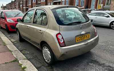 LC03 FYJ, a Gold Nissan Micra parked in Hollingdean