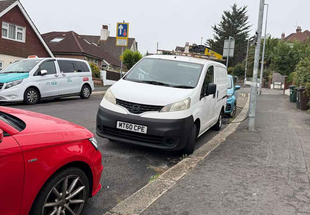 Photograph of MT60 CPE - a White Nissan NV200 parked in Hollingdean by a non-resident, and potentially abandoned. The sixth of fourteen photographs supplied by the residents of Hollingdean.