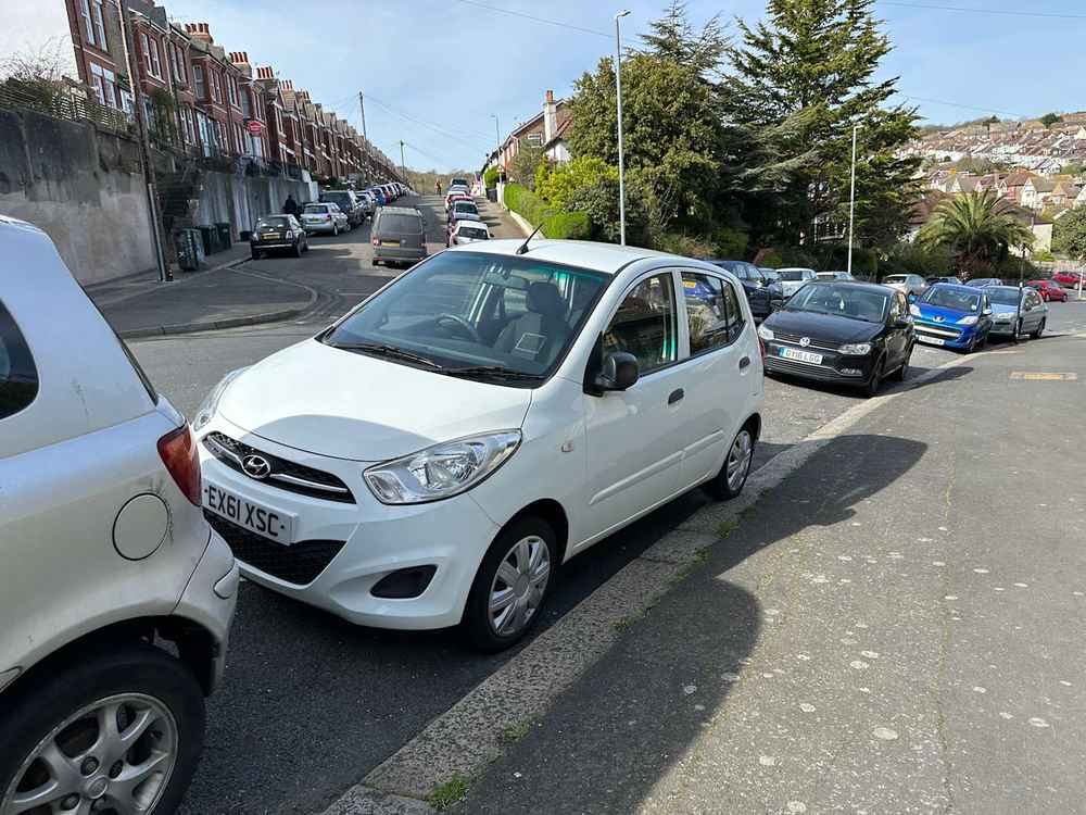 Photograph of EX61 XSC - a White Hyundai i10 parked in Hollingdean by a non-resident who uses the local area as part of their Brighton commute. The fourth of seven photographs supplied by the residents of Hollingdean.