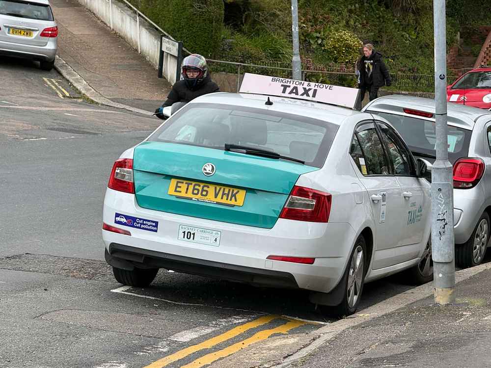 Photograph of ET66 VHK - a White Skoda Octavia taxi parked in Hollingdean. The fifth of six photographs supplied by the residents of Hollingdean.