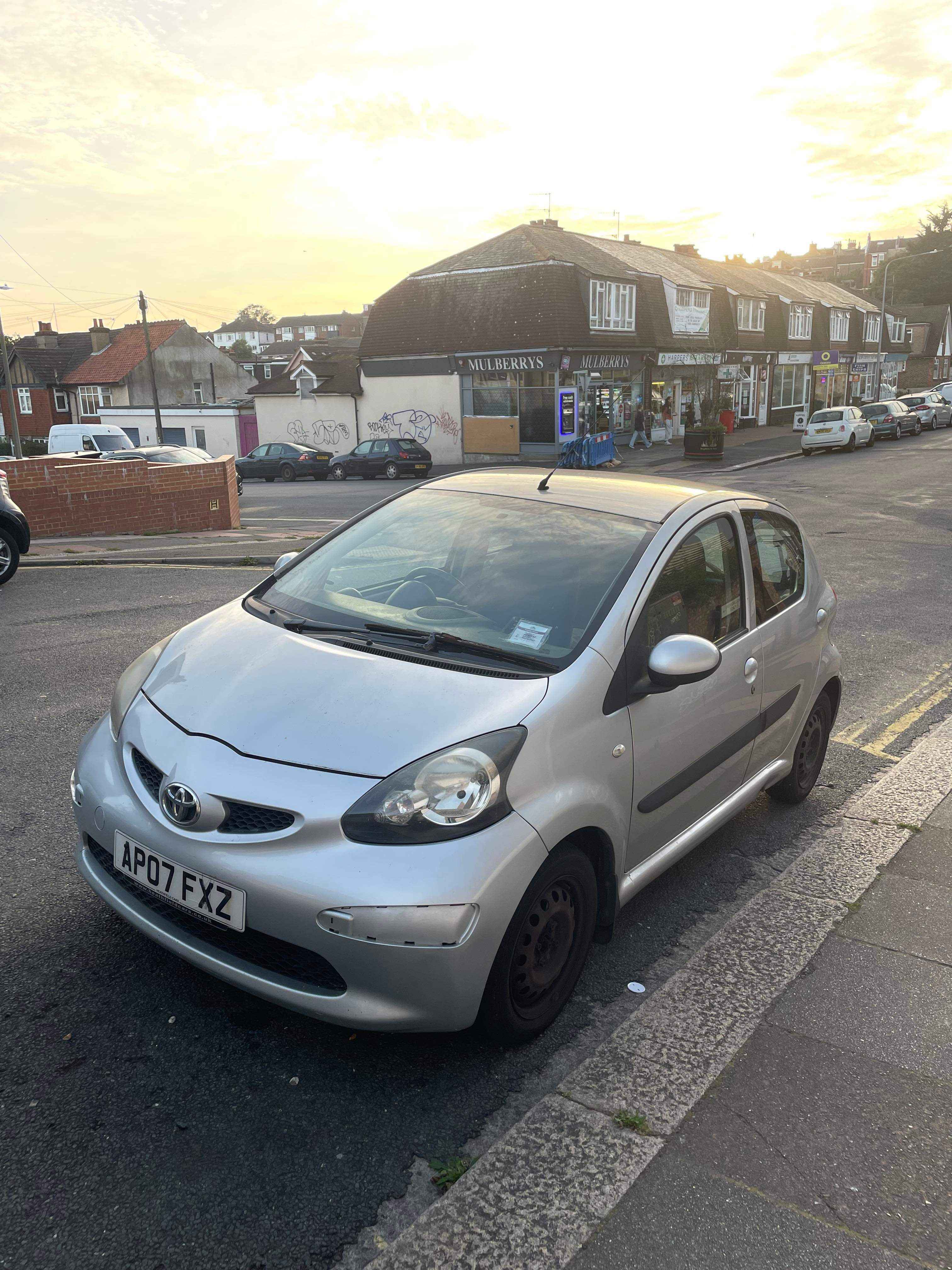 Photograph of AP07 FXZ - a Silver Toyota Aygo parked in Hollingdean by a non-resident, and potentially abandoned. The second of three photographs supplied by the residents of Hollingdean.