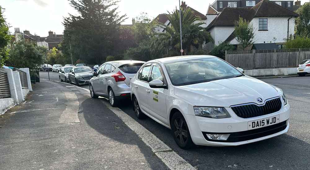 Photograph of DA15 WJD - a White Skoda Octavia taxi parked in Hollingdean by a non-resident. The eleventh of nineteen photographs supplied by the residents of Hollingdean.