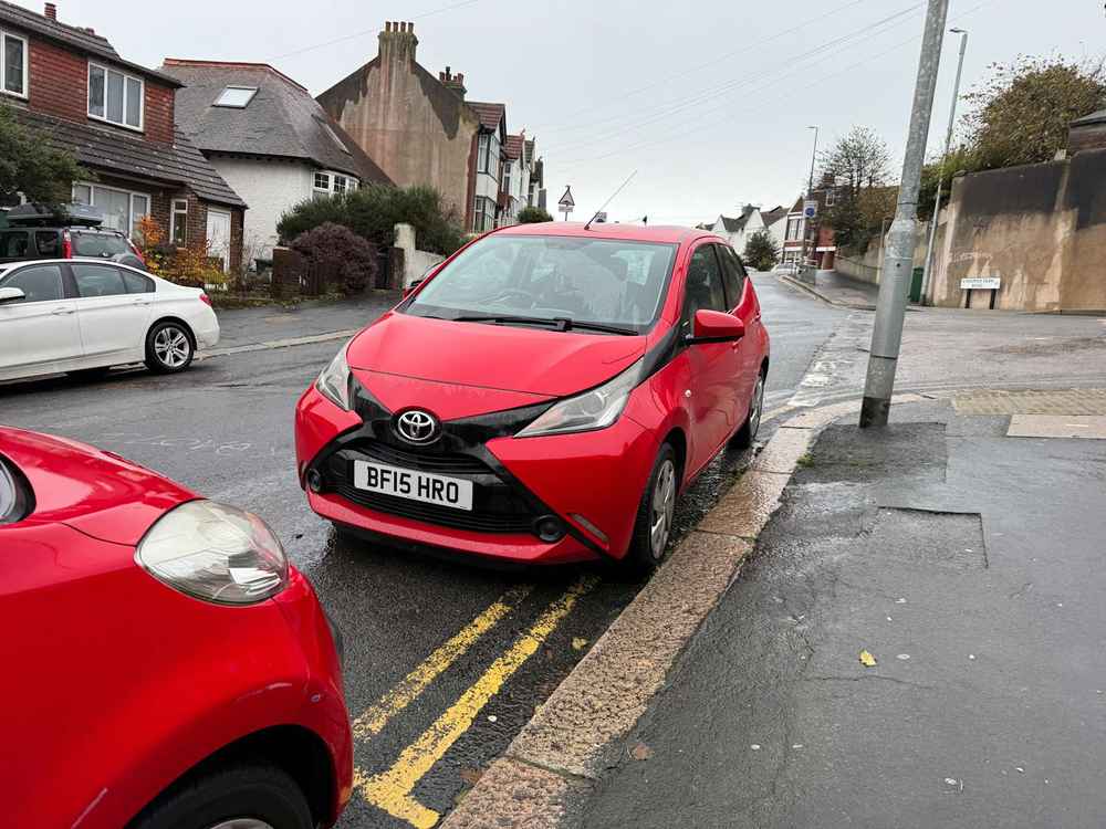 Photograph of BF15 HRO - a Red Toyota Aygo parked in Hollingdean by a non-resident who uses the local area as part of their Brighton commute. The first of four photographs supplied by the residents of Hollingdean.