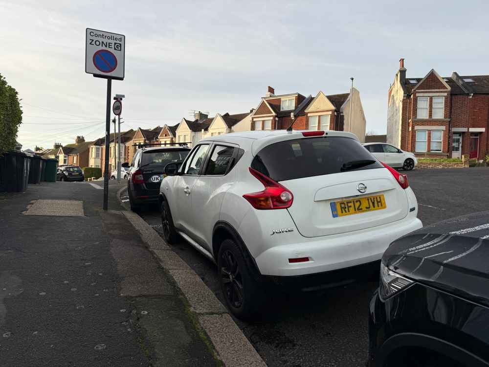 Photograph of RF12 JVH - a White Nissan Juke parked in Hollingdean by a non-resident who uses the local area as part of their Brighton commute. The tenth of ten photographs supplied by the residents of Hollingdean.