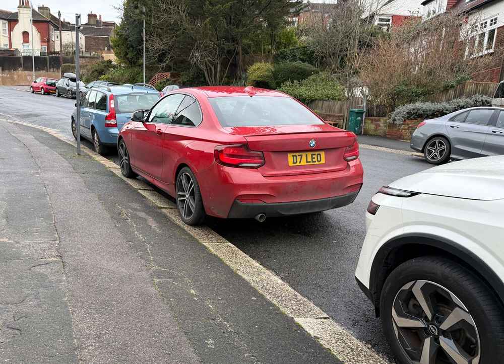 Photograph of D7 LEO - a Red BMW 2 Series parked in Hollingdean by a non-resident who uses the local area as part of their Brighton commute. The third of three photographs supplied by the residents of Hollingdean.
