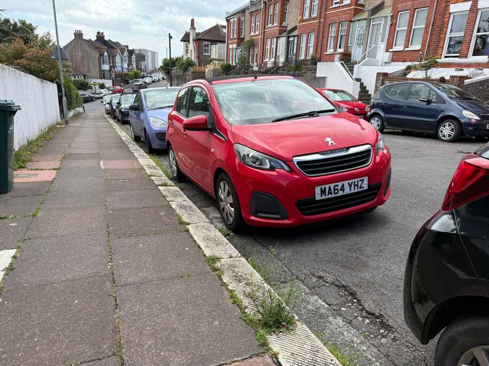 Photograph of MA64 YHZ - a Red Peugeot 108 parked in Hollingdean by a non-resident who uses the local area as part of their Brighton commute. The fourteenth of fourteen photographs supplied by the residents of Hollingdean.