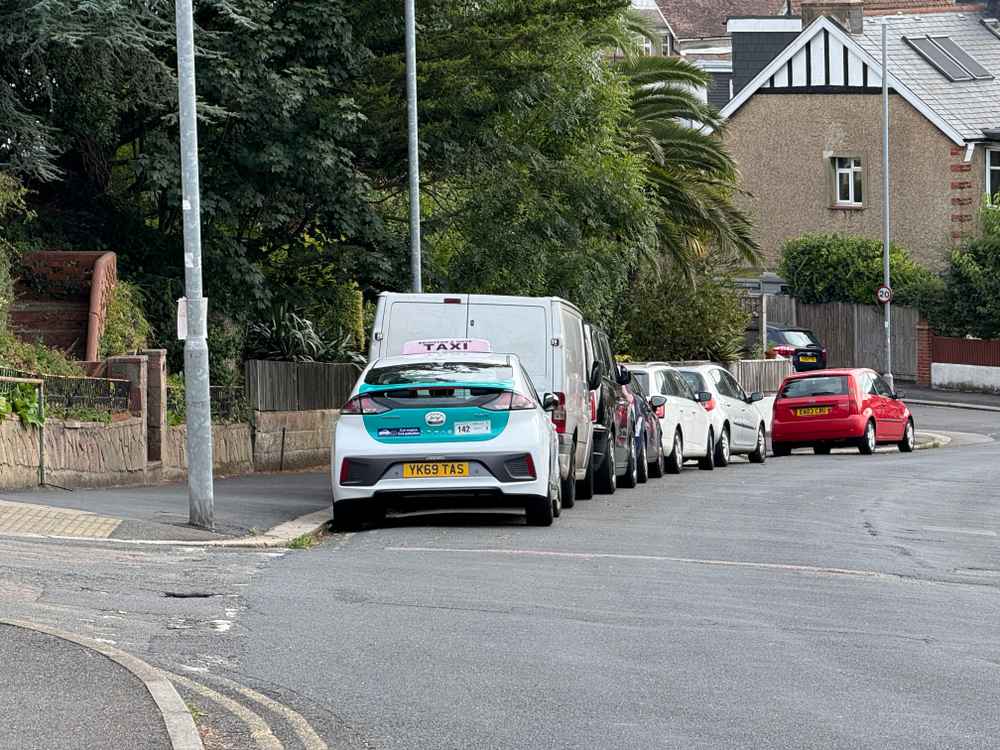 Photograph of YK69 TAS - a White Hyundai Ioniq taxi parked in Hollingdean by a non-resident. The eleventh of eleven photographs supplied by the residents of Hollingdean.