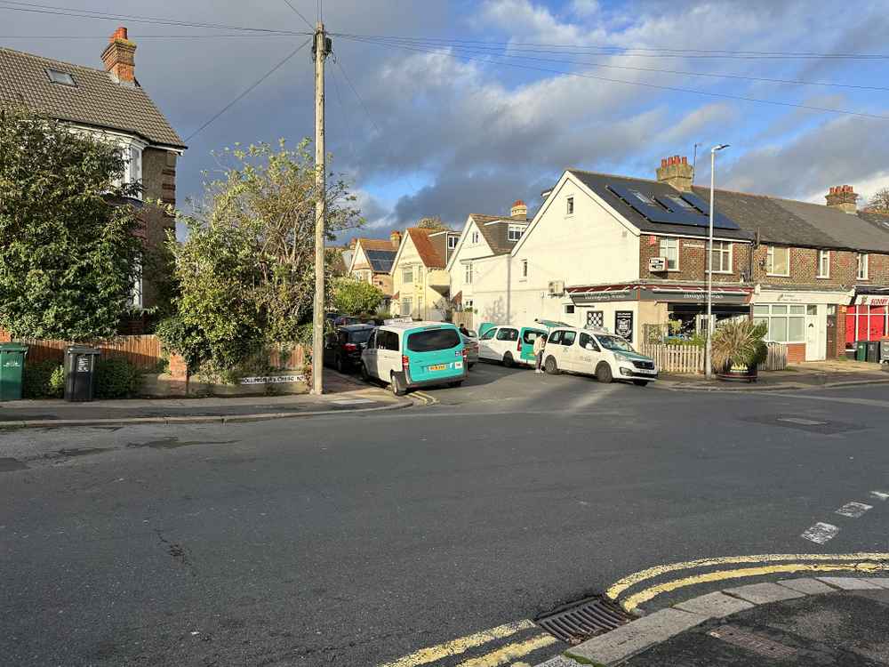 Photograph of SF12 LUR - a White Peugeot Partner taxi parked in Hollingdean by a non-resident, and potentially abandoned. The third of three photographs supplied by the residents of Hollingdean.