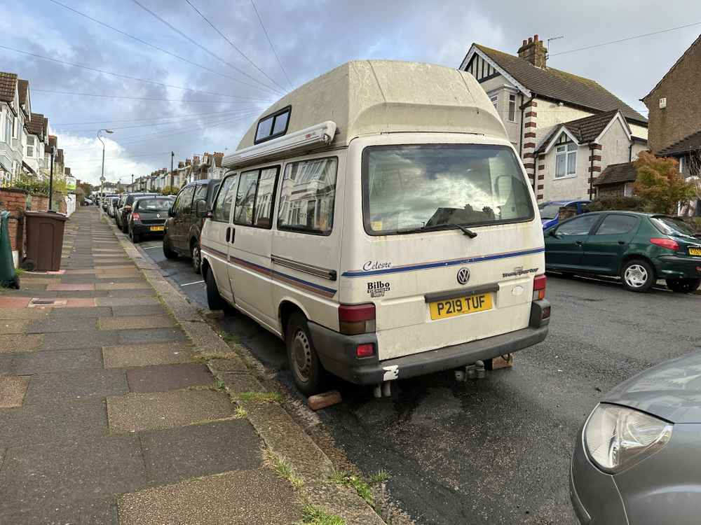 Photograph of P219 TUF - a Cream Volkswagen Transporter camper van parked in Hollingdean by a non-resident, and potentially abandoned. 