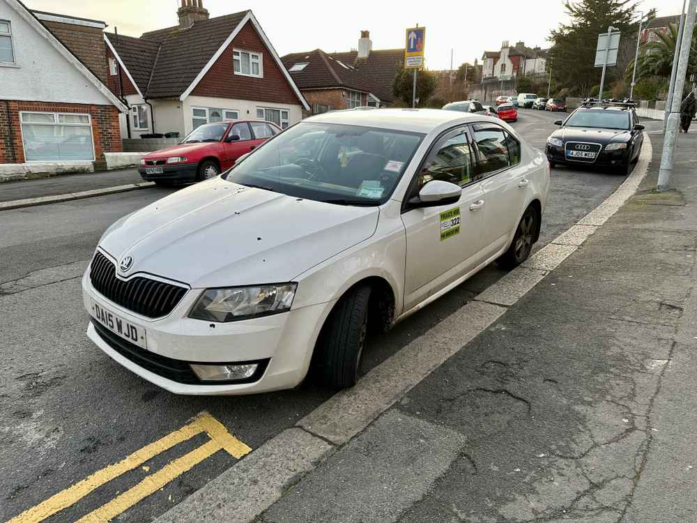 Photograph of DA15 WJD - a White Skoda Octavia taxi parked in Hollingdean by a non-resident. The fifth of ten photographs supplied by the residents of Hollingdean.