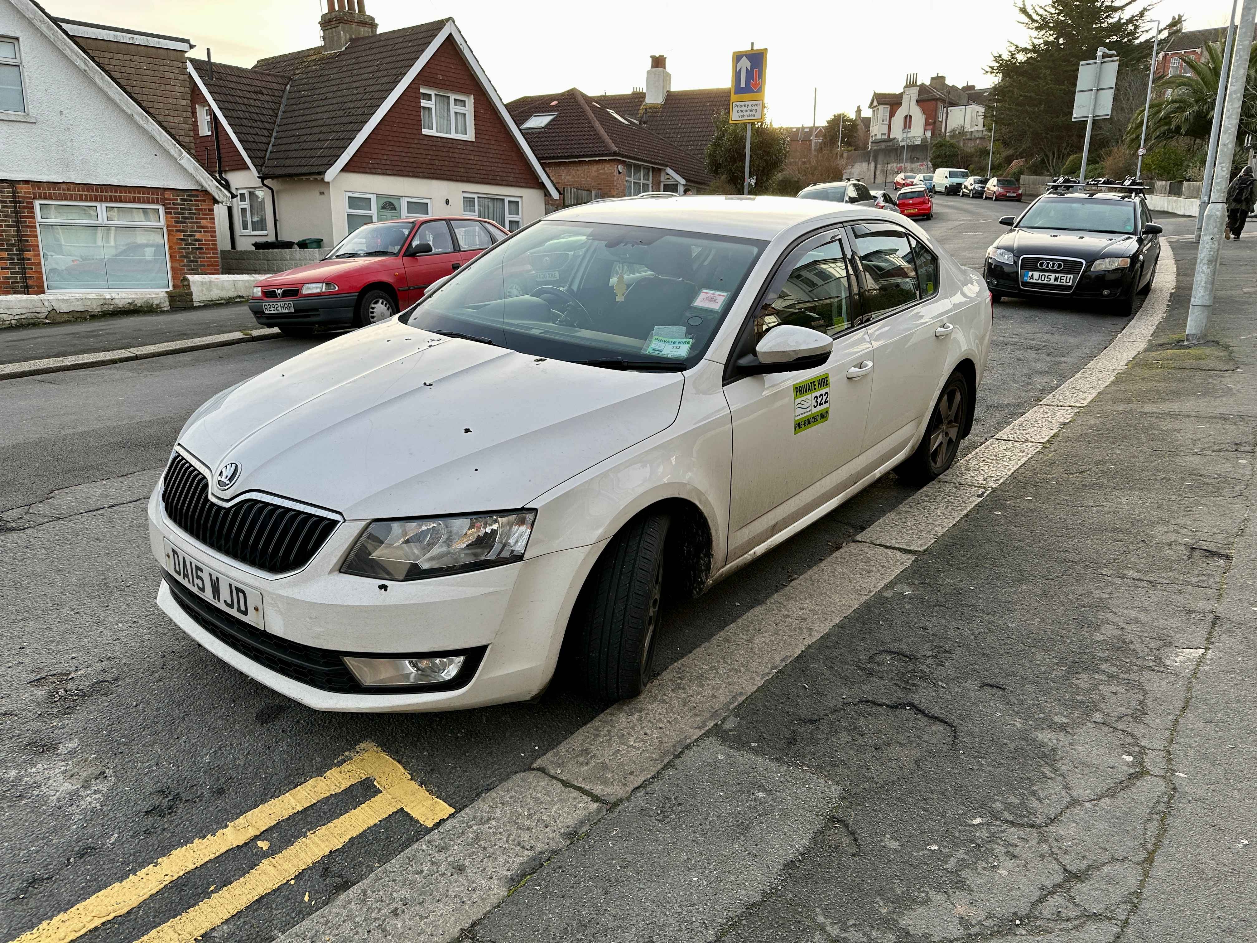 Photograph of DA15 WJD - a White Skoda Octavia taxi parked in Hollingdean by a non-resident. The fifth of five photographs supplied by the residents of Hollingdean.
