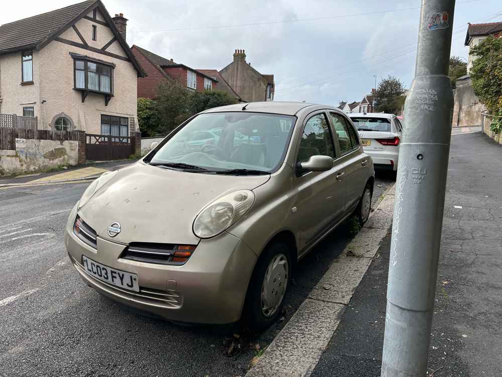 Photograph of LC03 FYJ - a Gold Nissan Micra parked in Hollingdean by a non-resident, and potentially abandoned. The ninth of twenty-three photographs supplied by the residents of Hollingdean.