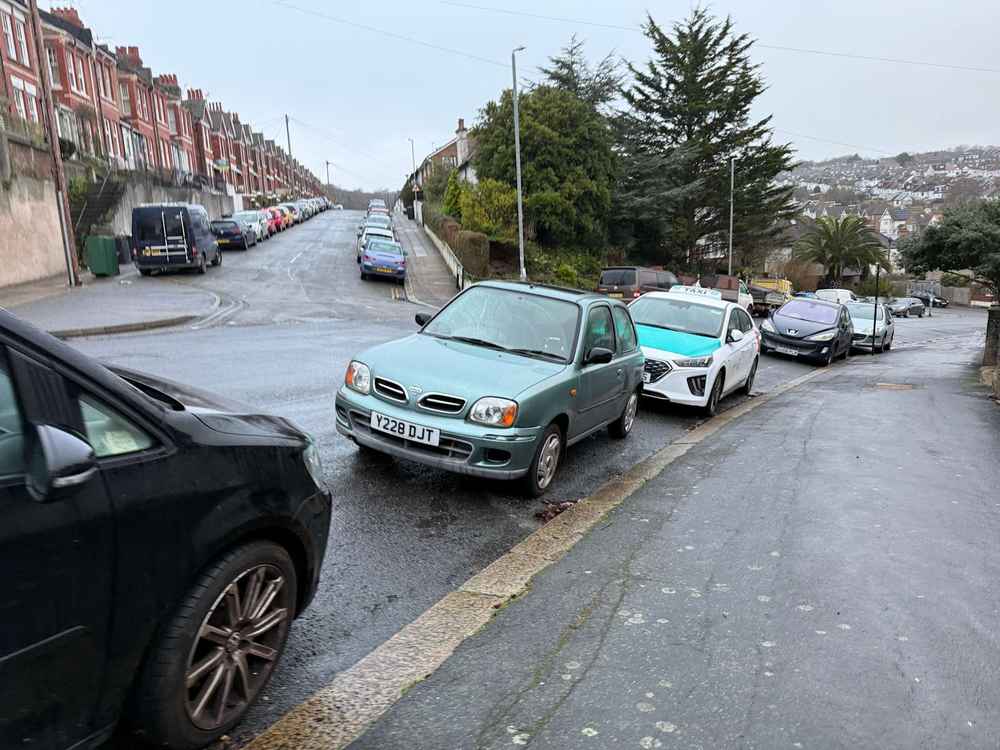 Photograph of Y228 DJT - a Green Nissan Micra parked in Hollingdean by a non-resident, and potentially abandoned. The sixth of nine photographs supplied by the residents of Hollingdean.