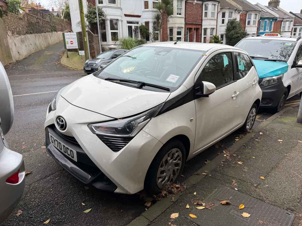 Photograph of GY70 DCO - a White Toyota Aygo parked in Hollingdean by a non-resident. The third of three photographs supplied by the residents of Hollingdean.