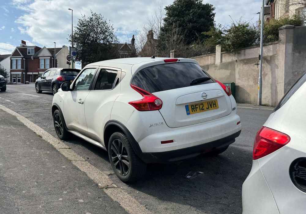 Photograph of RF12 JVH - a White Nissan Juke parked in Hollingdean by a non-resident who uses the local area as part of their Brighton commute. The thirteenth of twenty-five photographs supplied by the residents of Hollingdean.