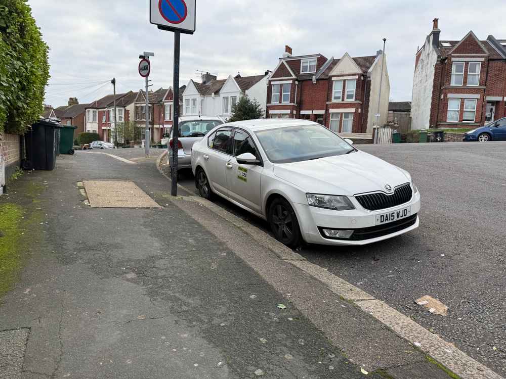 Photograph of DA15 WJD - a White Skoda Octavia taxi parked in Hollingdean by a non-resident. The thirteenth of thirteen photographs supplied by the residents of Hollingdean.