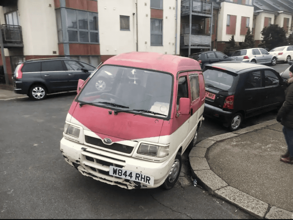 Photograph of W844 RHR - a Pink Daihatsu Hijet camper van parked in Hollingdean by a non-resident, and potentially abandoned. The second of three photographs supplied by the residents of Hollingdean.