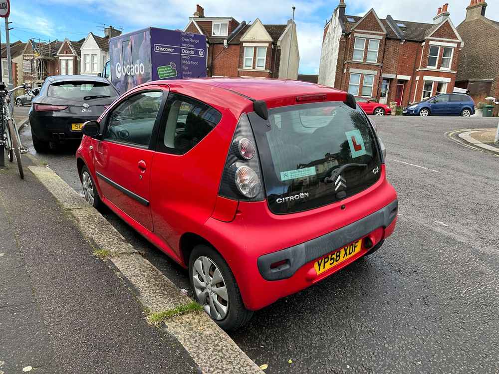 Photograph of YP58 XDF - a Red Citroen C1 parked in Hollingdean by a non-resident, and potentially abandoned. The sixth of twenty photographs supplied by the residents of Hollingdean.