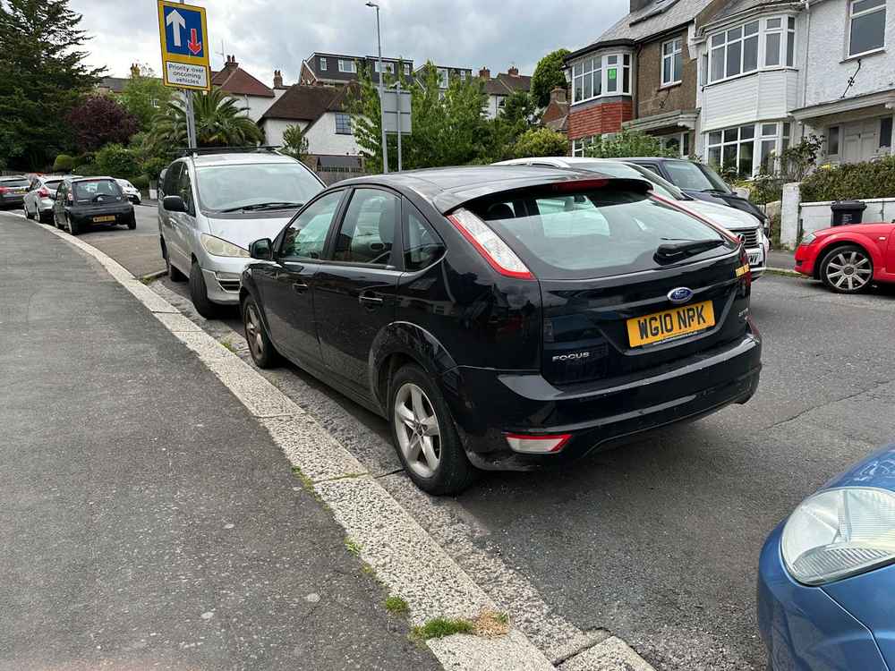Photograph of WG10 NPK - a Black Ford Focus parked in Hollingdean by a non-resident. The first of seventeen photographs supplied by the residents of Hollingdean.
