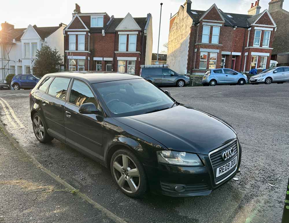 Photograph of RE09 DOU - a Black Audi A3 parked in Hollingdean by a non-resident who uses the local area as part of their Brighton commute. The sixth of eight photographs supplied by the residents of Hollingdean.