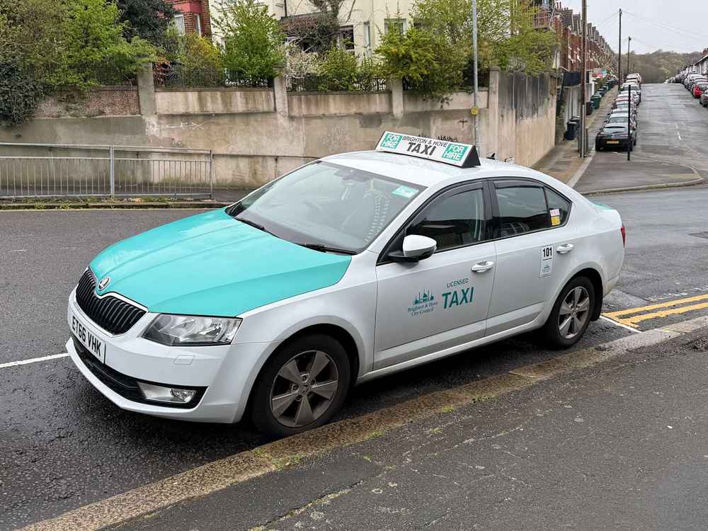 Photograph of ET66 VHK - a White Skoda Octavia taxi parked in Hollingdean. The sixth of six photographs supplied by the residents of Hollingdean.